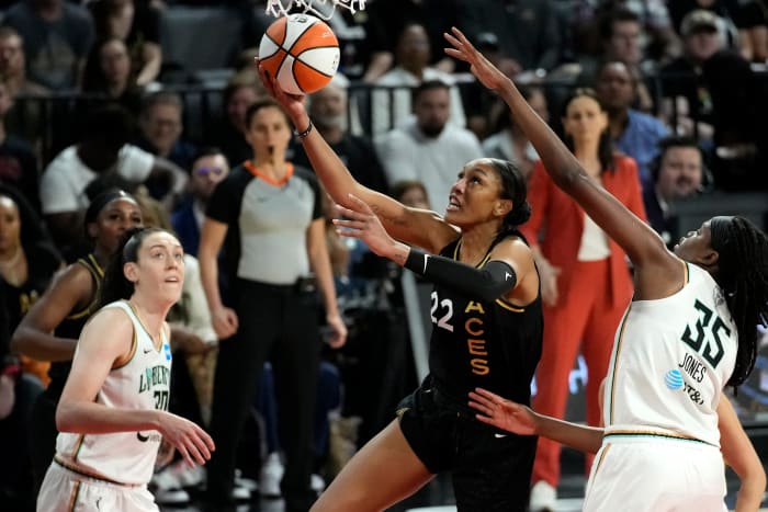 Las Vegas Aces forward A’ja Wilson shoots around New York Liberty players Jonquel Jones and Breanna Stewart during the WNBA Finals.
